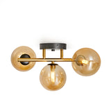 Guld loftslampe med 3 ravgule glaskugler