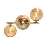 Guld loftslampe med 3 ravgule glaskugler